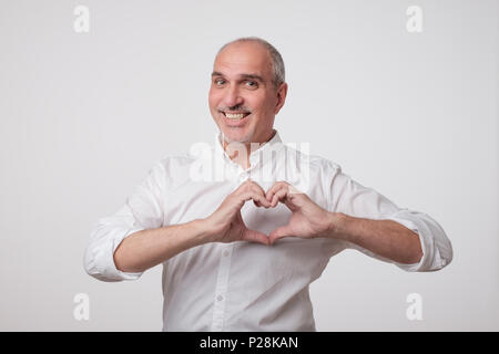 old european man making out of hands heart. Stock Photo