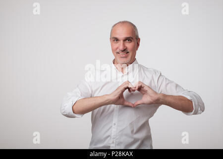 old european man making out of hands heart. Stock Photo