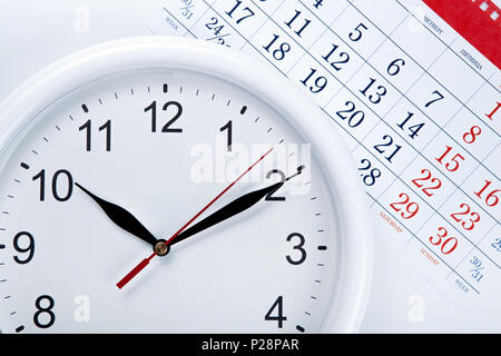 clock face and calendar sheet with numbers closeup Stock Photo