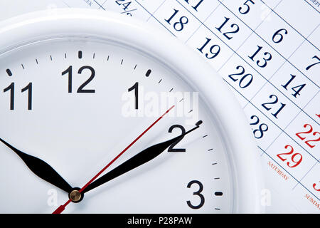 clock face and calendar sheet with numbers closeup Stock Photo