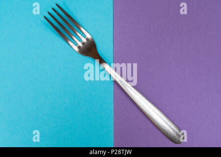 a fork on a two colored surface Stock Photo