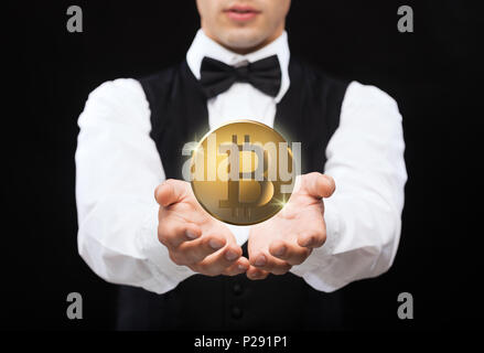 close up of magician with bitcoin over black Stock Photo
