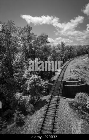 Black and white train tracks beside bridge landscape Stock Photo