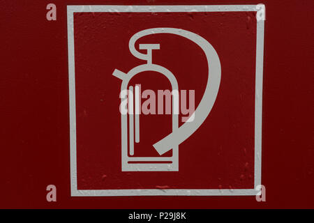 fire extinguisher sign retro style on red background in white lines front view Stock Photo