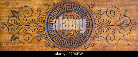 Old worn wooden carved decorative panel, typical door decoration of 19th century with carved oriental ornament, may be used as background or texture Stock Photo