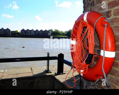 Life buoy in foreground of View toward Rotherhithe outside the Captain Kidd pub, Wapping, London, England. Stock Photo