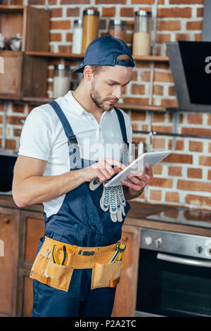 handsome young professional home master using digital tablet Stock Photo