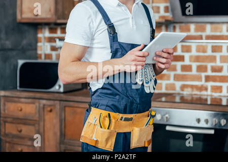 cropped shot of professional home master using digital tablet Stock Photo