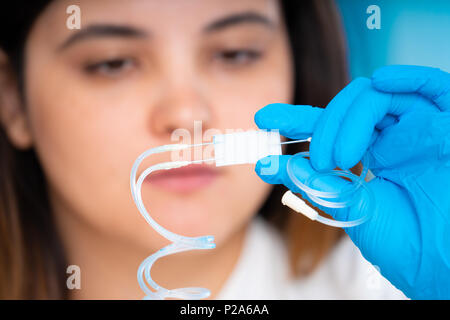 technician girl with microfluidic device LOC in microbiological lab Stock Photo