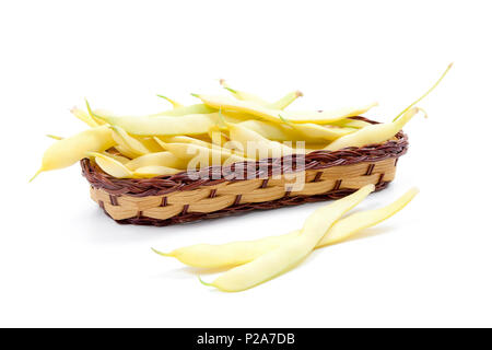 Yellow wooden basket with young pods of beans with beans isolated on white background Stock Photo