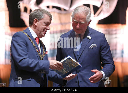 The Prince of Wales (right) receives a gift from the Lord Mayor of Cork Tony Fitzgerald (left) during a civic reception at City Hall in Cork as part of his tour of the Republic of Ireland. Stock Photo