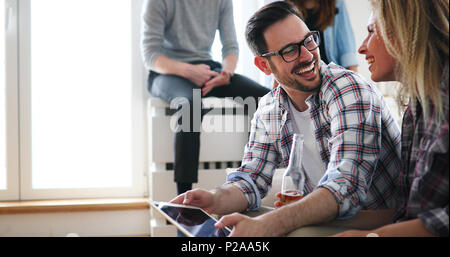 Relaxed couple or friends using tablet together to shop online Stock Photo