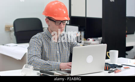 Young architect working on the laptop in office Stock Photo