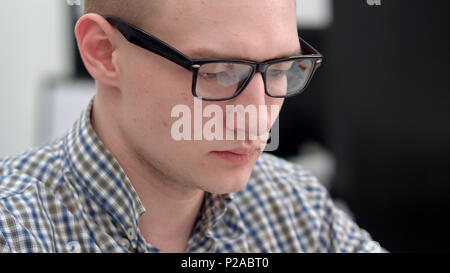Young man in glasses working in the office Stock Photo