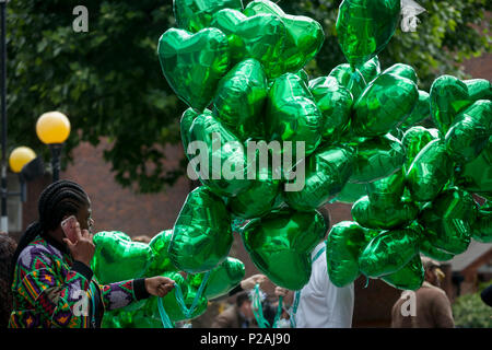 London, UK. 14th Jun, 2018.  Green heart-shaped balloons during the memorial service for the Grenfell fire on the first anniversary of the tower block disaster. 72 people died when the tower block in the borough of Kensington & Chelsea were killed in what has been called the largest fire since WW2. The 24-storey Grenfell Tower block of public housing flats in North Kensington, West London, United Kingdom. It caused 72 deaths, out of the 293 people in the building, including 2 who escaped and died in hospital. Over 70 were injured and left traumatised. Credit: RichardBaker/Alamy Live News Stock Photo