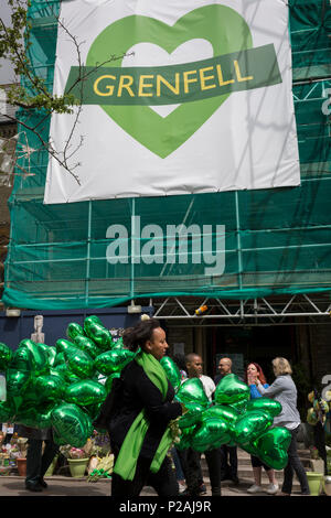 London, UK. 14th Jun, 2018.  Green heart-shaped balloons during the memorial service for the Grenfell fire on the first anniversary of the tower block disaster. 72 people died when the tower block in the borough of Kensington & Chelsea were killed in what has been called the largest fire since WW2. The 24-storey Grenfell Tower block of public housing flats in North Kensington, West London, United Kingdom. It caused 72 deaths, out of the 293 people in the building, including 2 who escaped and died in hospital. Over 70 were injured and left traumatised. Credit: RichardBaker/Alamy Live News Stock Photo