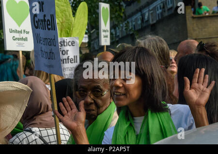 London, UK. 14th June 2018. A community associatin leader poses for the camer as thousands line up to walk in silence from close to Grenfell Tower remembering the victims of the disaster on the first anniversary of the disastrous fire which killed 72 and left survivors traumatised. Many of those made homeless by the fire are still in temporary accomodation a year later despite promises mde by Theresa May and Kensington & Chelsea council, who many fell have failed the local community both before and after the fire. They say had they been listened to and respected Grenfell would not have happene Stock Photo