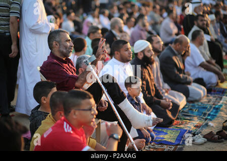 Gaza,Palestine. 15th June 2018 , Palestinians Muslims pray Eid on the eastern border of Gaza city near the fence with Israel, and take part in Eid prayers a lot of people who were shot in the foot . photo By: Mohamed Zarandah Credit: mohamed zarandah/Alamy Live News Stock Photo