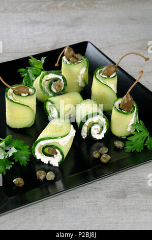 Cucumber rolls with ricotta filling and capers.   These rolls with the size of a bite -is a great option with a low fat content, which serves as a sna Stock Photo