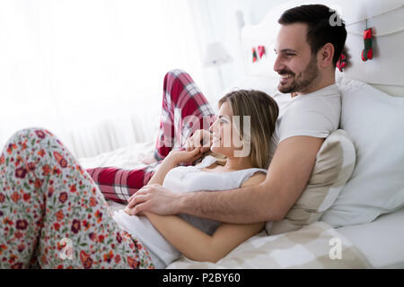 Portrait of young loving couple in bedroom Stock Photo