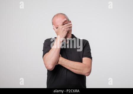 Facepalm. Portrait a disappointed mature man Stock Photo