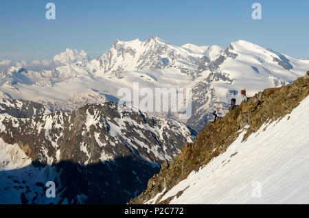 Three alpinists on the south ridge of the Weissmies, in the background, from left to right, Monte Rosa, Lyskamm and Strahlhorn, Stock Photo