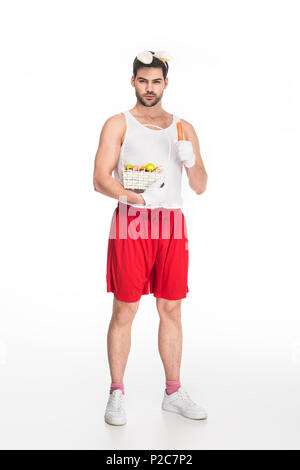 Man with bunny ears holding basket of fruits and carrot isolated on white, easter concept Stock Photo
