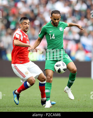 Russia's Aleksandr Samedov (left) and Saudi Arabia's Abdullah Otayf battle for the ball during the FIFA World Cup 2018, Group A match at the Luzhniki Stadium, Moscow. Stock Photo