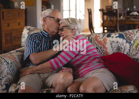 Romanced senior couple sitting on sofa Stock Photo