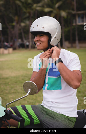 Man wearing helmet in the park Stock Photo