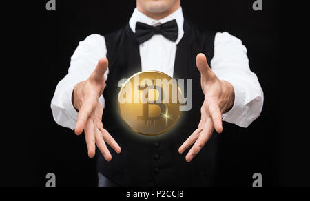 close up of magician with bitcoin over black Stock Photo