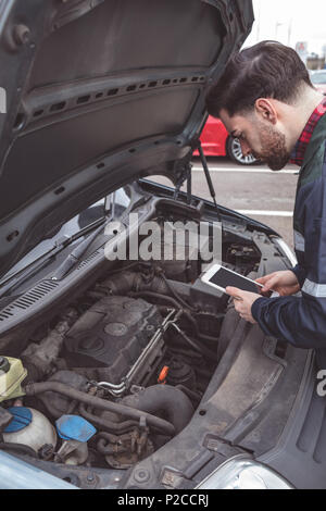 Male mechanic using digital tablet Stock Photo