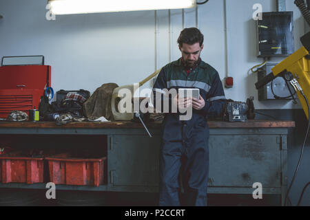 Mechanic using digital tablet Stock Photo
