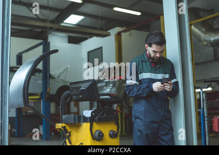 Mechanic using mobile phone Stock Photo