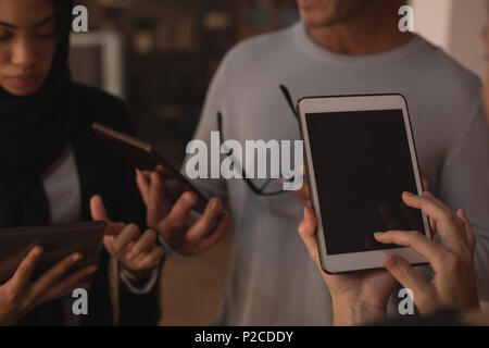 Business colleagues using digital tablet and laptop Stock Photo