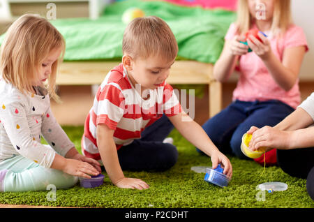 kids and mother with modelling clay or slimes Stock Photo