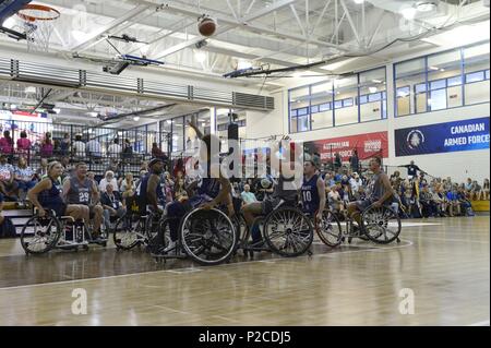 Army Sgt. 1st Class Brant Ireland from Team SOCOM takes a shot against Navy in the wheelchair basketball game during the 2018 Warrior Games held at the Air Force Academy in Colorado Springs June 4, 2018, June 4, 2018. Several members of Team SOCOM advanced to the finals. Created in 2010, the DoD Warrior Games introduce wounded, ill and injured service members and veterans to Paralympic-style sports. Warrior Games showcases the resilient spirit of today's wounded, ill or injured service members from all branches of the military. These athletes have overcome significant physical and behavioral i Stock Photo