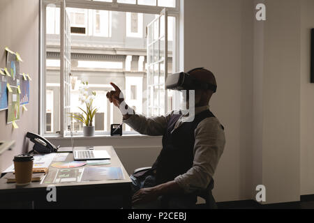 Senior graphic designer using virtual reality headset Stock Photo
