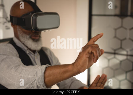 Senior graphic designer using virtual reality headset Stock Photo