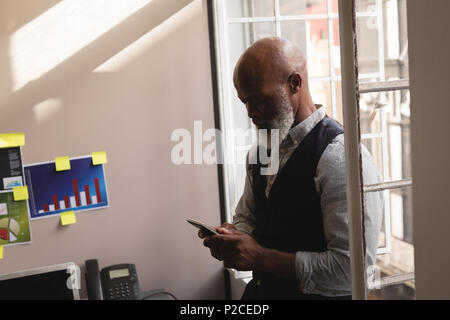 Senior graphic designer using mobile phone Stock Photo