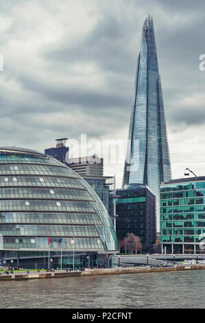 The curved glass building in spherical shape of the City Hall of London and The Shard, the tallest building in the UK, iconic landmark of London, UK Stock Photo