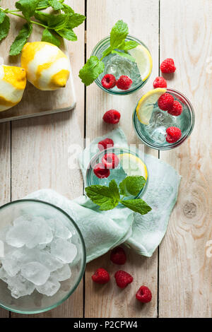 Refreshing iced summer drinks garnished with fresh fruit and mint Stock Photo