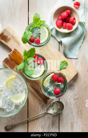Refreshing iced summer drinks garnished with fresh fruit and mint Stock Photo