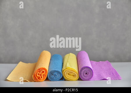Spiral pattern on ends of colored paper twisted into roll. Stock Photo