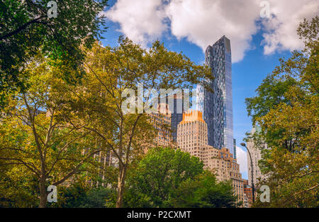 Standing in Central Park, looking over to Manhattan in New York City through the trees Stock Photo