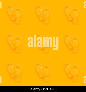 Seamless pattern background of yellow flip flops on same color background. Beach sandals or slippers in minimalistic warm summer toned composition. Stock Photo