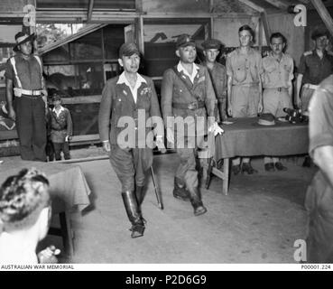 . English: Solomon Islands, September 8th, 1945. Lieutenant General Masatane Kanda, commander of 17th Army, and Vice-Admiral Tomoshige Samejima, commander 8th Fleet, enter in the II Australian Corps HQ at Torokina (Bougainville Island) where they signed the instrument of surrender of all Japanese forces in the Southwest Pacific. 8 September 1945. Unknown 22 General Kanda and Vice-Admiral Samejima at Torokina for surrender ceremony. September 8th, 1945 Stock Photo