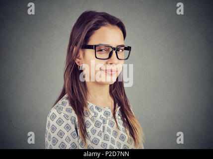 Sly tricky young woman looking at camera. Liar concept. Stock Photo