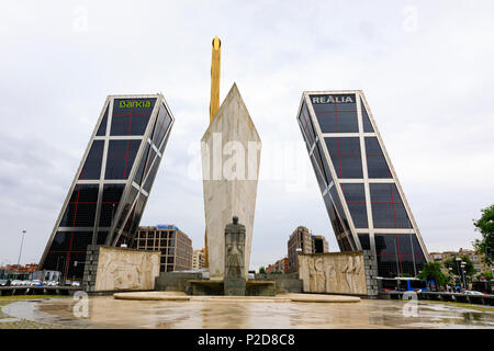 The twin leaning towers of the Gateway to Europe, Puerto de Europa, with the Obelisco de la Caja and the granite statue of Duke Jose Calvo Sotelo. Mad Stock Photo