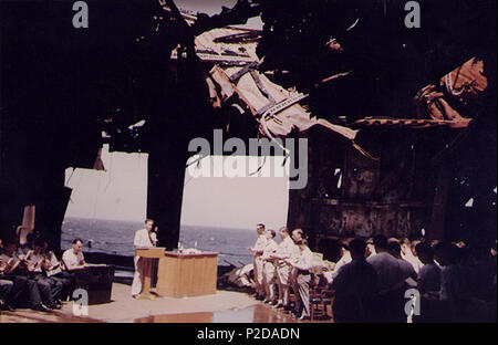 . Church service on the ruined hangar deck of the U.S. Navy aircraft carrier USS Franklin (CV-13), taken upon her return to the U.S. from the Pacific for repair of battle damage received off Japan on 19 March 1945. Location is probably in, or near, New York Harbor (USA), circa 28 April 1945. circa 28 April 1945. USN 15 Curch service aboard damaged USS Franklin (CV-13) in 1945 Stock Photo